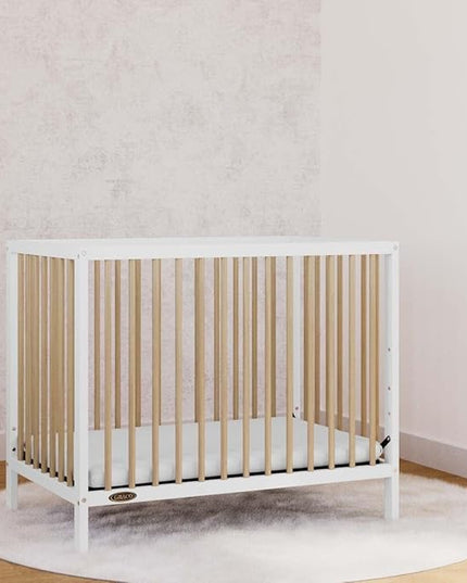 Graco Teddi 4-in-1 Convertible Mini Crib with Bonus Water-Resistant Mattress (White with Driftwood) – GREENGUARD Gold Certified, 2.75-Inch Mattress Included, Convenient Size, Easy 30-Minute Assembly - LeafyLoom
