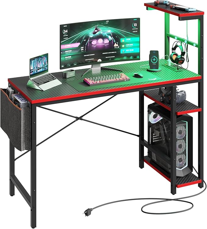 Bestier Gaming Desk with Power Outlets, 44 Inch Led Gamer Desk with 4 Tiers Reversible Shelves, PC Gaming Table with Headset Hook & Side Storage Bag for Bedroom (Black 3D Carbon Fiber) - LeafyLoom