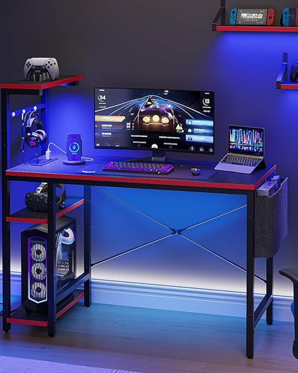 Bestier Gaming Desk with Power Outlets, 44 Inch Led Gamer Desk with 4 Tiers Reversible Shelves, PC Gaming Table with Headset Hook & Side Storage Bag for Bedroom (Black 3D Carbon Fiber) - LeafyLoom