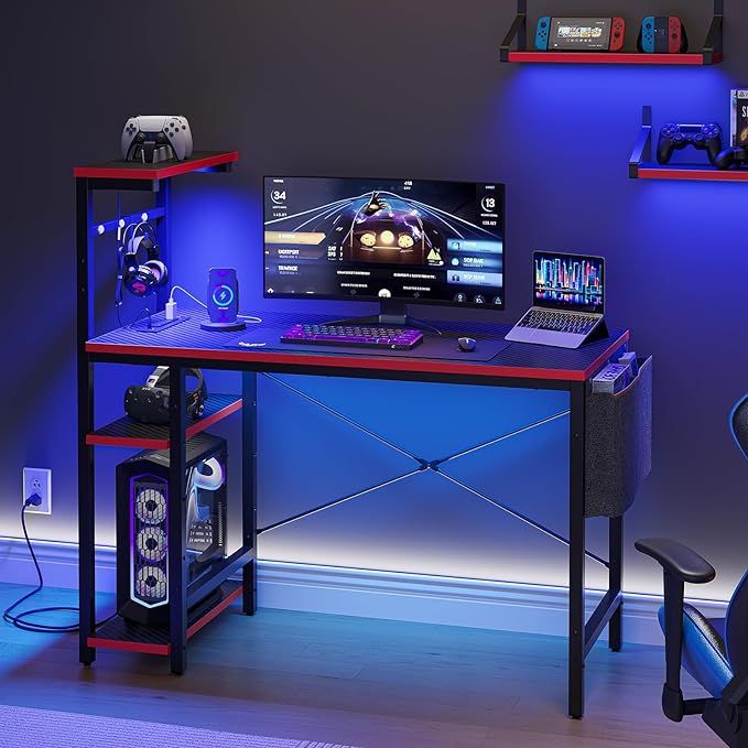 Bestier Gaming Desk with Power Outlets, 44 Inch Led Gamer Desk with 4 Tiers Reversible Shelves, PC Gaming Table with Headset Hook & Side Storage Bag for Bedroom (Black 3D Carbon Fiber) - LeafyLoom