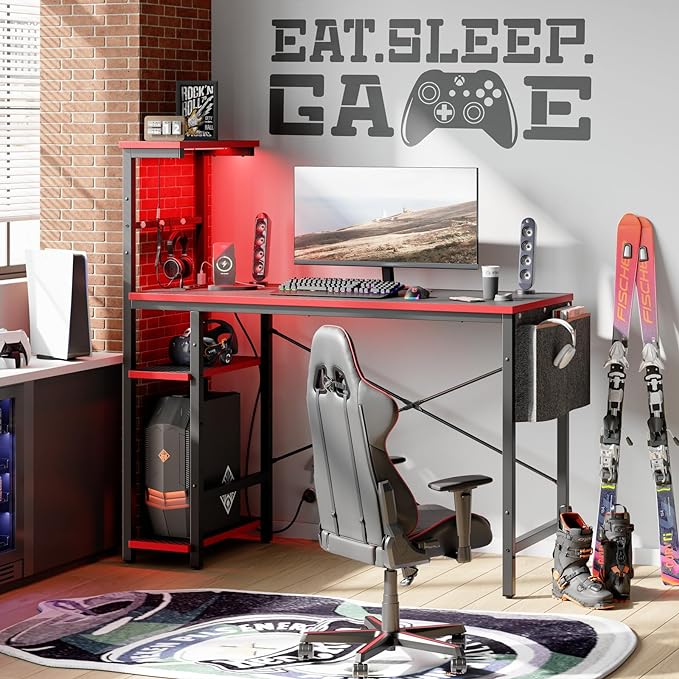 Bestier Gaming Desk with Power Outlets, 44 Inch Led Gamer Desk with 4 Tiers Reversible Shelves, PC Gaming Table with Headset Hook & Side Storage Bag for Bedroom (Black 3D Carbon Fiber) - LeafyLoom